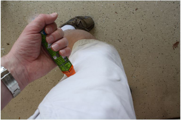 EpiPen pressed into victim's thigh through clothing
